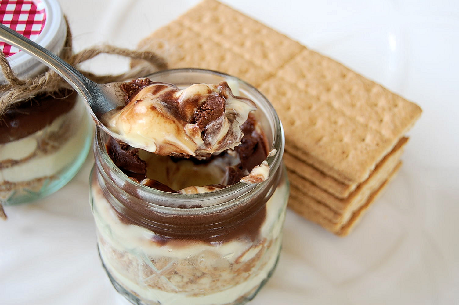 http://www.justusfourblog.com/2013/09/mason-jar-fever-chocolate-eclair-cake-in-a-jar/